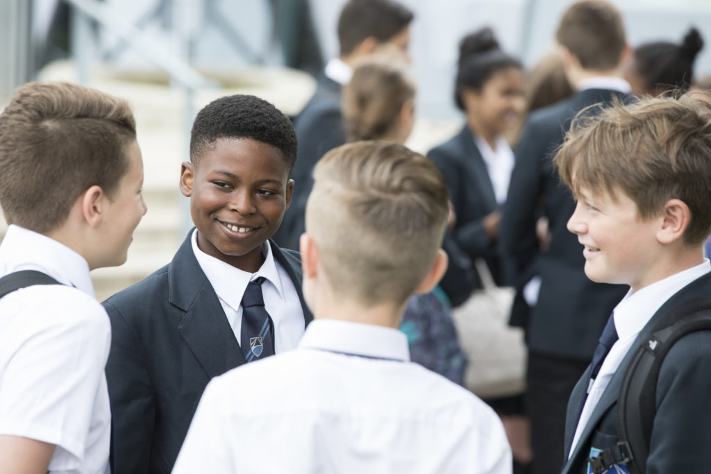 Photo of four male Leigh Academy students standing together in a group.