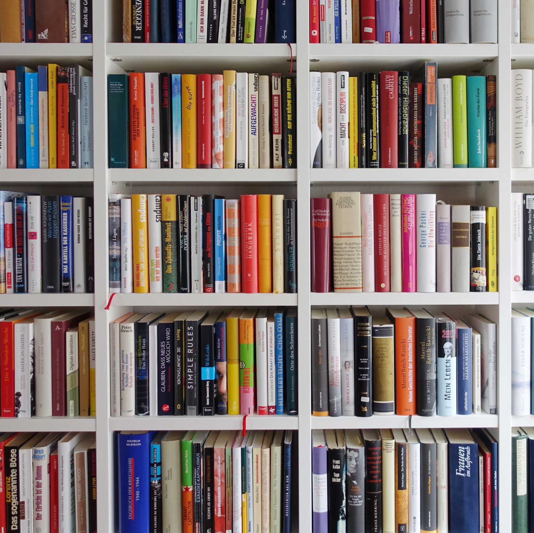 Photo of a large bookshelf filled with many different books.