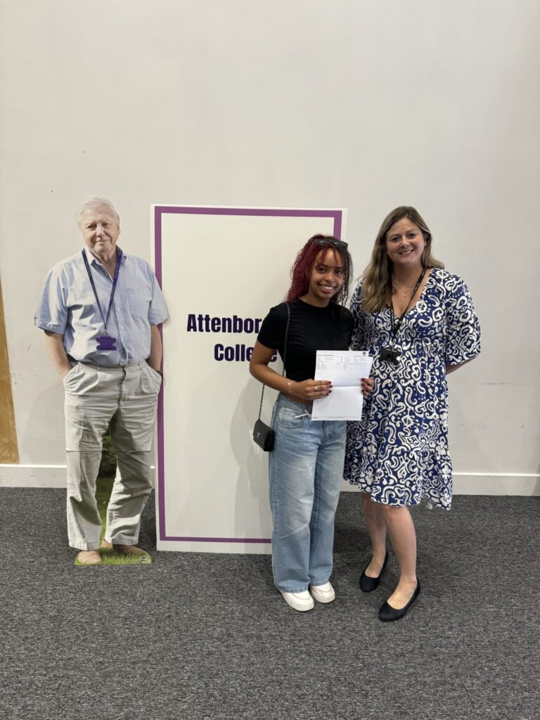 Student holding their results with Julia Collins